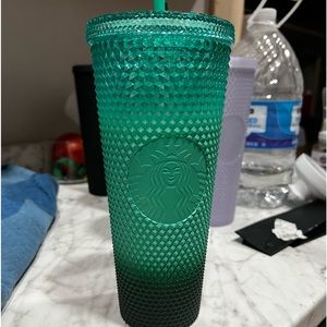 Green studded Starbucks cup